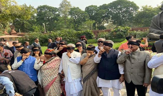 tmc-leaders-hold-a-blindfolded-protest-near-gandhi-statue-at-the-parliament tmc-leaders-hold-a-blindfolded-protest-near-gandhi-statue-at-the-parliament