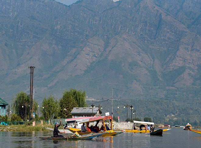 डल झील में शिकारा की सवारी का आनंद लेते पर्यटक